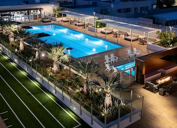 An aerial view of the rooftop and community pool at Garden at 3Roots apartment complex.