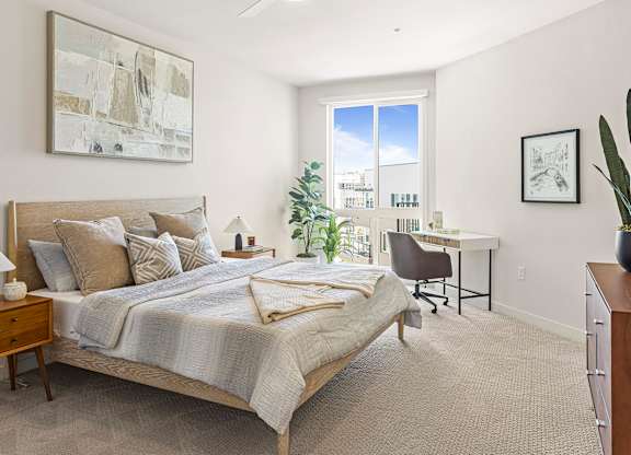 A spacious apartment bedroom with ample natural light.