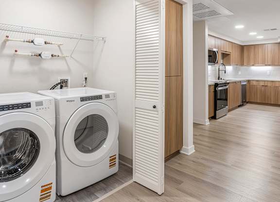 A laundry room with a washer and dryer in it.