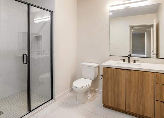 A white toilet sits next to a sink in a bathroom.