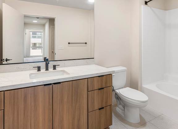 A modern bathroom with a white sink and a white toilet.