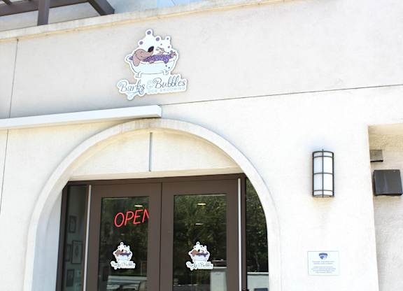 Dog grooming salon entrance with branding at Torrey Gardens Apartments, California, 92130