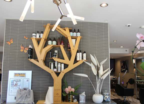 Salon reception with tree shaped product display shelving at Torrey Gardens Apartments, California
