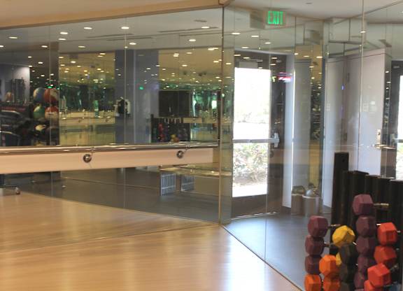 Retail storefront entrance with glass doors and display at Torrey Gardens Apartments, San Diego, CA 92130