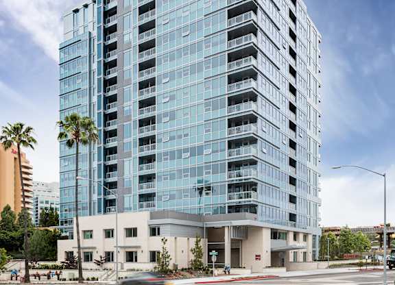 Modern glass highrise apartment building exterior at LUX by Garden* Apartments, San Diego, California