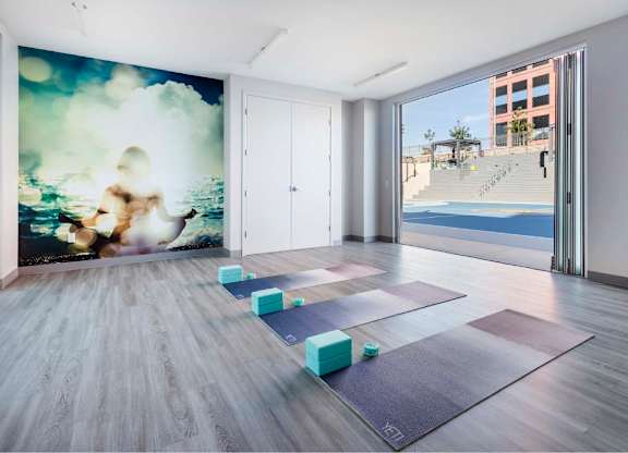Yoga studio with mats and blocks by open doors at 360 Luxury Apartments, San Diego, CA 92122
