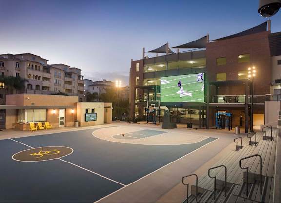 Sports court with bleacher seating and projection screen at 360 Luxury Apartments, San Diego, California
