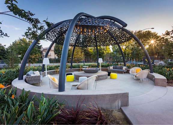 Outdoor pavilion with perforated canopy and seating areas at 360 Luxury Apartments, California, 92122