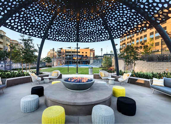 Fire pit seating under decorative perforated dome at 360 Luxury Apartments, San Diego