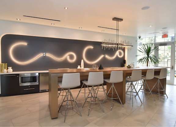 Community dining area with modern bar seating at 360 Luxury Apartments, California, 92122