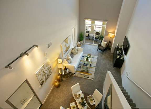 Two story loft living room with dining area at 360 Luxury Apartments, San Diego, CA 92122