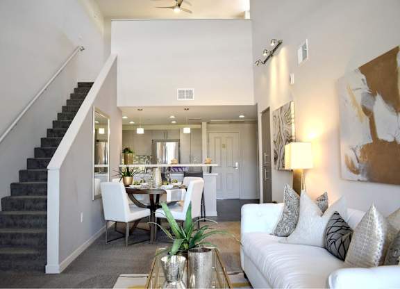 Two story living area with staircase and open dining space at 360 Luxury Apartments, San Diego, CA