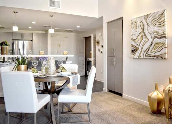 Dining area with contemporary furniture and gold decor at 360 Luxury Apartments, San Diego, 92122