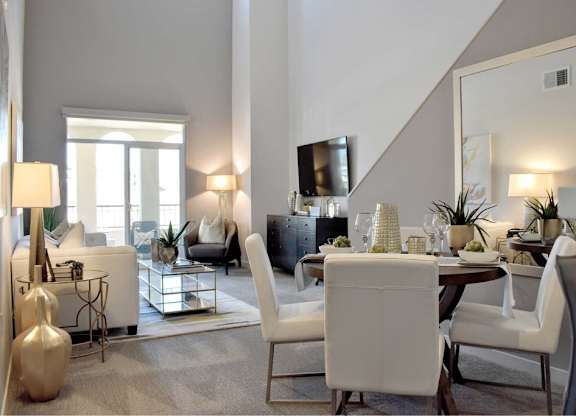 Open concept dining and living room with high ceilings at 360 Luxury Apartments, San Diego, California