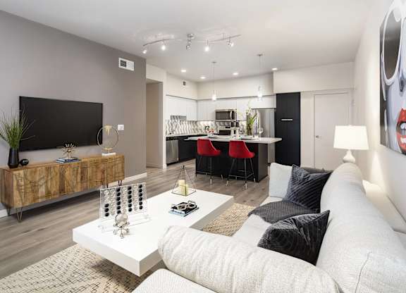 Modern open concept living area and kitchen at LUX by Garden* Apartments, California