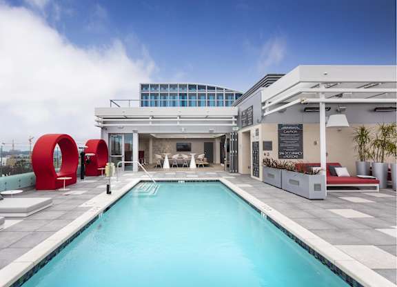Rooftop pool deck with seating at LUX by Garden* Apartments, California, 92122