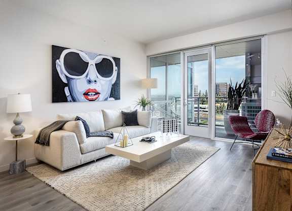 Bright living room with balcony and city views at LUX by Garden* Apartments, San Diego, 92122