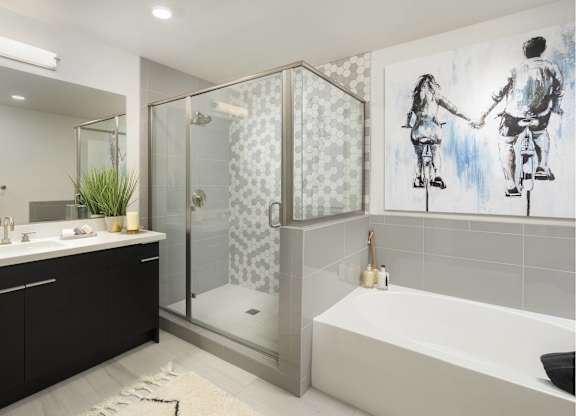 Modern bathroom with separate shower and tub at LUX by Garden* Apartments, San Diego, CA