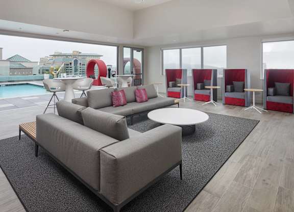 Rooftop lounge with private work booths and seating at LUX by Garden* Apartments, San Diego, California