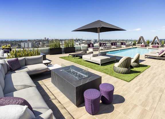Rooftop deck with pool fire feature and umbrella at LUX by Garden* Apartments, California, 92122