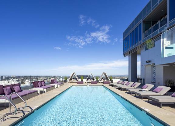 Rooftop pool with lounge chairs and cabanas at LUX by Garden* Apartments, San Diego, CA 92122
