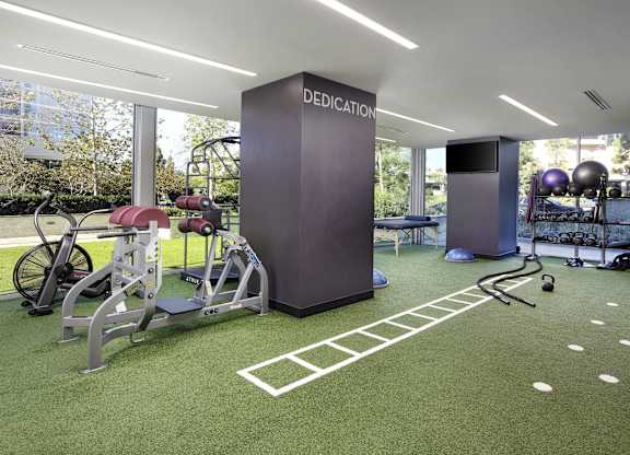 Fitness center with turf training area at LUX by Garden* Apartments, California