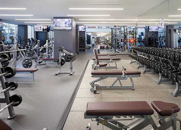Fitness center with free weights and workout benches at LUX by Garden* Apartments, California, 92122