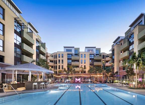 Resort style swimming pool with lap lanes and lounge area at Metropolis Apartments, California, 92614