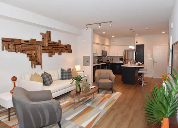 Open concept living room and kitchen with modern furnishings at Metropolis Apartments, California, 92614