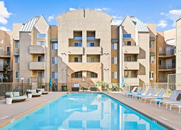 Swimming pool with lounge chairs and balconies at Costa Verde Village Apartments, California, 92122