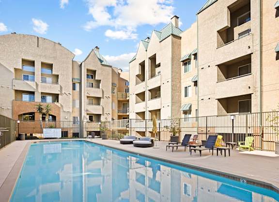 Courtyard pool with lounge chairs and balconies at Costa Verde Village Apartments, San Diego, CA