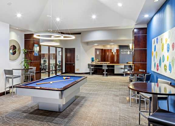 Game room with pool table and resident services desk at Costa Verde Village Apartments, California