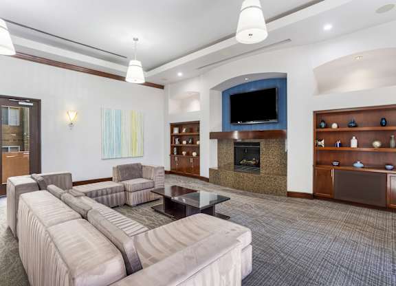 Community lounge with fireplace and built in shelving at Costa Verde Village Apartments, San Diego, CA