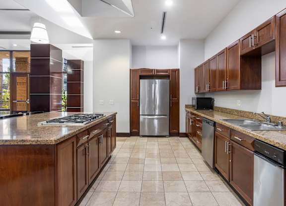 Shared kitchen with granite countertops and wood cabinets at Costa Verde Village Apartments, San Diego, 92122