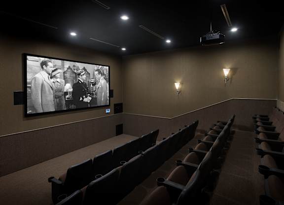 Private home theater with tiered stadium seating at Costa Verde Village Apartments, San Diego, CA