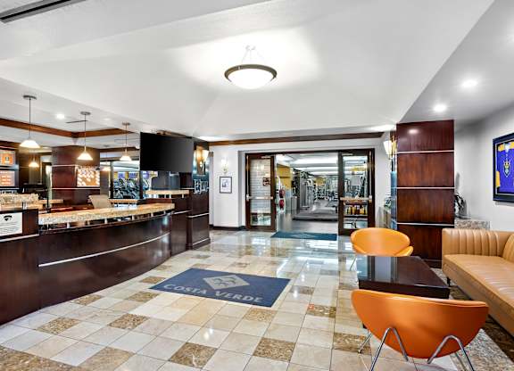 Lobby with reception desk and fitness center entrance at Costa Verde Village Apartments, San Diego, 92122