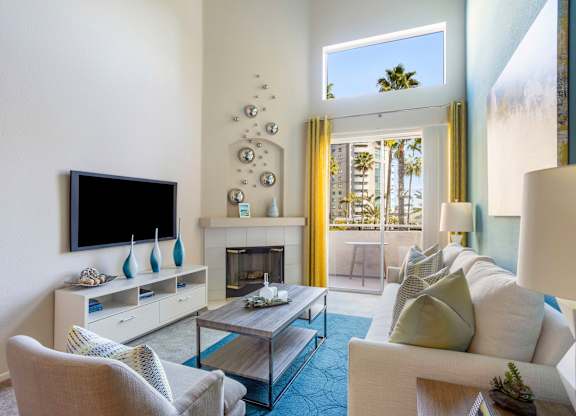 Living room with fireplace and patio access at Costa Verde Village Apartments, San Diego