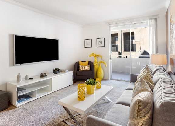 Contemporary living room with modern furniture and balcony at Costa Verde Village Apartments, San Diego, CA