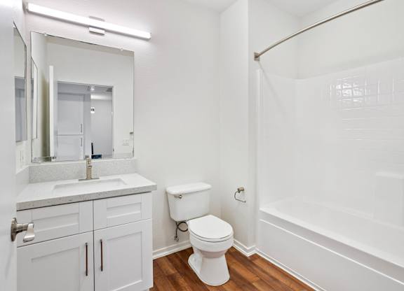 Bathroom with white vanity and subway tile surround at Costa Verde Village Apartments, California