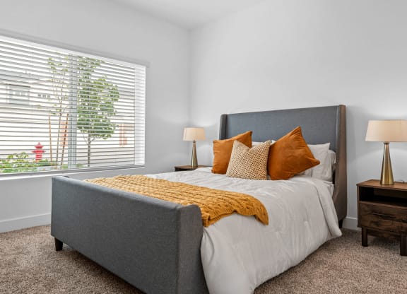 a bedroom with a bed and two night stands with lamps