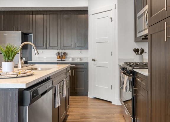 a kitchen with gray cabinets and a white door
