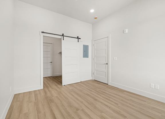 A room with a sliding door and a white door.