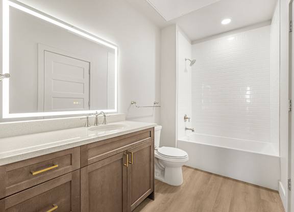 A modern bathroom with a white toilet and a white sink.
