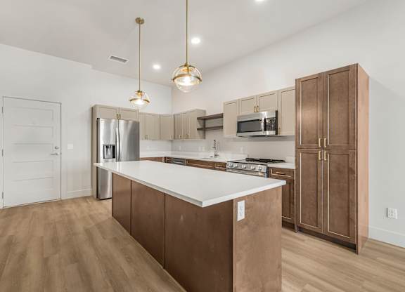 A kitchen with brown cabinets and a white countertop.