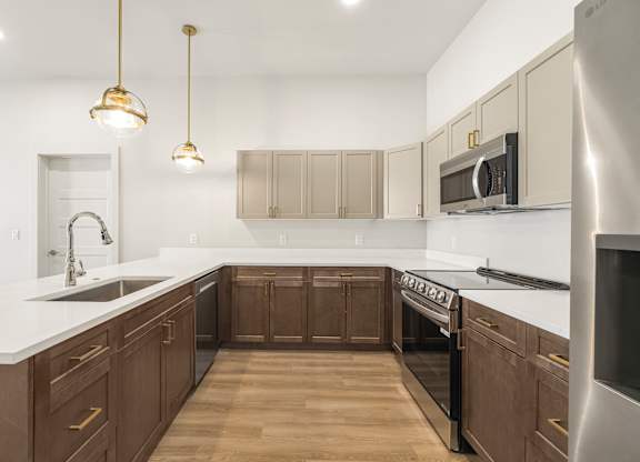 A kitchen with wooden cabinets and a white countertop.