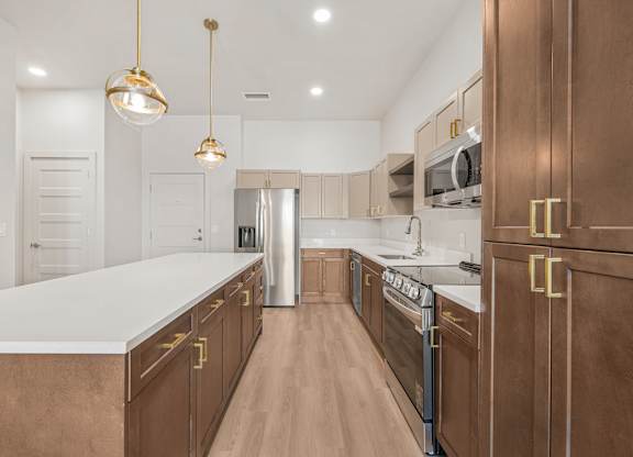 A kitchen with brown cabinets and a white countertop.