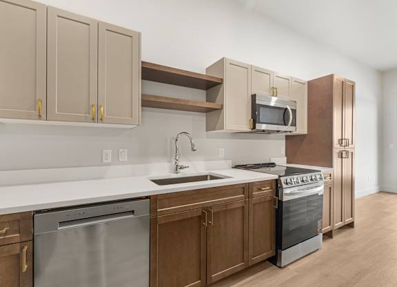 A kitchen with a stainless steel dishwasher and oven.
