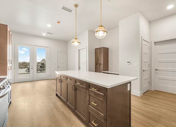 A kitchen with a white counter top and wooden cabinets.