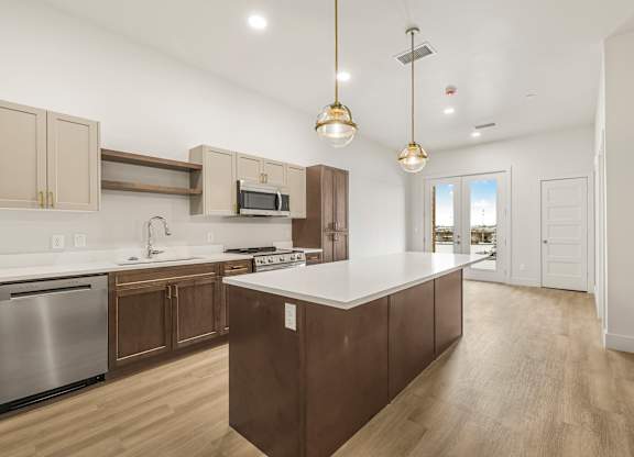 A modern kitchen with wooden cabinets and a central island.