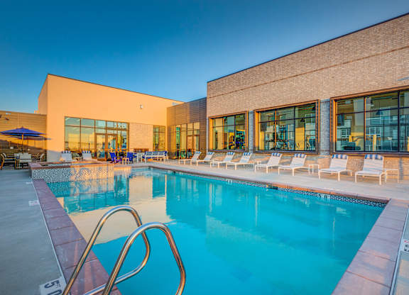 A large swimming pool with a metal ladder in the middle of it.